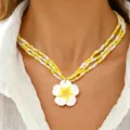 Detailed close-up shot of the Hawaiian plumeria multi-layer beaded necklace worn on neck. - Yellow and White