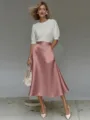 Detailed view of the smooth satin A-line midi skirt showcasing elegant drape and premium fabric. - Pink