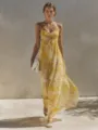 Detail view of a yellow floral slip dress with ruched bust and flowing long hemline. - S / Dresses / Yellow