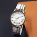 Detail shot of the women quartz watch featuring classic plaid fabric strap and round dial. - White