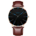 Minimalistische Quarzuhr mit braunem Lederarmband, Roségoldgehäuse und schwarzem Zifferblatt. - Gürtel Brauner Gürtel Rosa Muschel Blaue Nadel