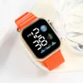 Close-up detail of the orange silicone strap and rose gold square digital watch screen. - Orange