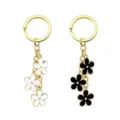 Portachiavi in metallo dorato elegante con graziosi ciondoli a fiore in smalto per donne. - Bianco e nero