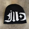 Detailed view of black and white knit beanie featuring gothic style typography and star moon graphics. - M (52-59) / Black & White