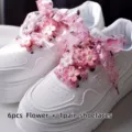 Detailed shot of white platform sneakers decorated with pink organza flower ribbon shoelaces. - Style 2