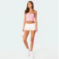 Full body view of a stylish pink strapless tube top paired with white shorts and sneakers. - S / Pink