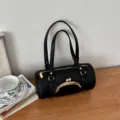 Black lychee pattern cylinder shoulder bag with metal kiss lock and double straps. - Black
