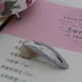 Close up detail of a grey blue ribbon wrapped bb hairpin, ideal for hair styling and decoration. - Gray