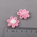 Closeup of handmade pink fabric flower accessories DIY craft detail view scale with ruler - Light Peach