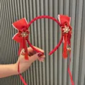 Red festival hair hoop with bows and tassels, perfect for kids New Year party and holiday style. - Brick Red Floral Tassel Headband