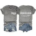Detailed view of the grey short sleeve t-shirt featuring custom senior text print. - S / Tops / Dark Grey (White Font)