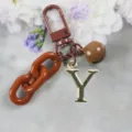 Porte-clés lettre Y dorée avec chaîne marron et clochette, accessoire de sac élégant. - Lettre Y