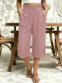 Detail view of casual women's cropped pants featuring elastic drawstring waist and side pockets. - S / Lotus Pink