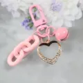 Pink alloy keychain with rhinestone heart pendant, acrylic chain and bell variant accessory. - Style 5