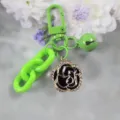 Green keychain with rhinestone camellia flower pendant, alloy keyring and cute bell accessory. - Style 6