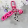 Pink metal keychain with rhinestone heart pendant, chunky chain and bell charm, stylish bag accessory. - Style 12