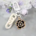 Chic black and gold camellia flower keychain with white resin chain and clasp for women. - Style 16