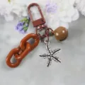 Stylish alloy keychain with brown chain, bell, and rhinestone flower pendant for daily fashion. - Style 20
