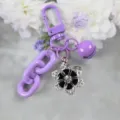 Purple keychain with flower pendant, colorful chain, and bell charm for stylish daily bags. - Style 21