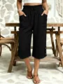 Detail shot of women casual cropped pants, elastic waist, pocket and button decor. - S / Black