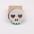 DIY Halloween felt skull patch with red glitter heart eyes, cute craft accessory for decoration. - White