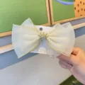 Cream white mesh bow hair clip for kids with a sparkly gold crown. Cute hair accessory. - Off White