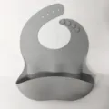 Waterproof silicone baby bib with crumb catcher pocket and adjustable neck strap for toddlers feeding. - Gray