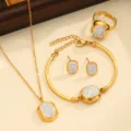 Gold stainless steel jewelry set featuring necklace bracelet earrings and ring with sparkling crystals. - Style 03 / White Rhinestone