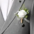 Elegant white rose boutonniere with green leaves and twine for weddings and formal events - White Artificial Baby's Breath Boutonniere