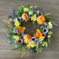 Detailed shot of colorful artificial floral wreath with peonies, roses and eucalyptus leaves. - Style B (Orange Peony)