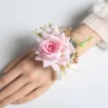 Elegant pink artificial rose wrist flower corsage with gold accents for wedding party guest. - Pink Heart Wrist Flower
