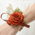 Rustic orange artificial rose wrist flower, elegant wedding corsage with ribbon and leaf decor. - Orange Wrist Corsage