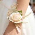 Elegant artificial rose wrist corsage with gold leaves and ribbon for wedding party decor. - Champagne Wrist Corsage