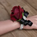 Burgundy rose wrist corsage detail with black ribbon and sparkly rhinestones for wedding. - Bridal Wrist Corsage