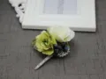 Detailed view of a wedding boutonniere with white rose, green flower, and blue berries. - 8*12mm / Green