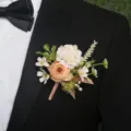 Wedding floral boutonniere detail shot, elegant fabric flower suit accessory for groom. - Corsage / Light Orange