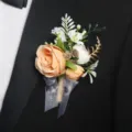Peach artificial rose wedding boutonnière groom corsage with ribbon and rustic greenery. - Boutonniere Style D