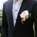 Close-up detail of wedding groom calla lily boutonniere with natural burlap twine wrap. - Light Pink