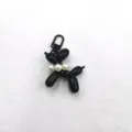 Black acrylic balloon dog keychain pendant with white pearls charm for bags and phone cases. - Black