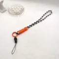 Handmade woven phone strap detail, black white houndstooth and orange paracord design, adjustable. - Long Rope / Black White/Orange