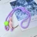 Close-up detail of the purple and pink cross-body phone lanyard with adjustable plastic buckle. - Light Purple