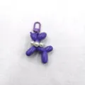 Detailed view of cute purple balloon dog acrylic keychain with pearl decor for bags. - Purple