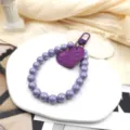Sangle de dragonne perles violettes avec pendentif cœur accessoire élégant pour téléphone portable - Violet