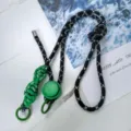 Black and white speckled crossbody phone lanyard with green braided design and adjustable buckle. - Black & White Fine Stripes - Green Knot