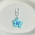 Gros plan du joli porte-clés fleur bleu clair avec centre violet et fermoir blanc. - [Bleu] Porte-clés fleur large