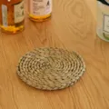 Detail view of a handcrafted natural straw coaster, showcasing rustic woven texture. - Rush Mats (15 cm)