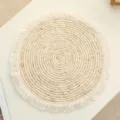 Close-up detail of the woven straw placemat showing neat handmade texture and fringe edge. - 25cm Corn Husk Rope Placemat with Tassels