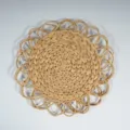 Round straw placemat detail showcasing natural woven texture and decorative edge for dining. - 34cm Double Layer Flower Water Hyacinth Mat
