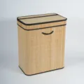 Detailed view of the bamboo woven storage basket with lid, black edges, and handle. - 52*32*62 cm / Natural Bamboo With Black Lining And Letter Print