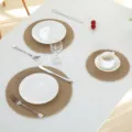 Close-up detail of natural jute woven placemat on white table with elegant tableware setup. - Jute Machine Stitched Round 11cm